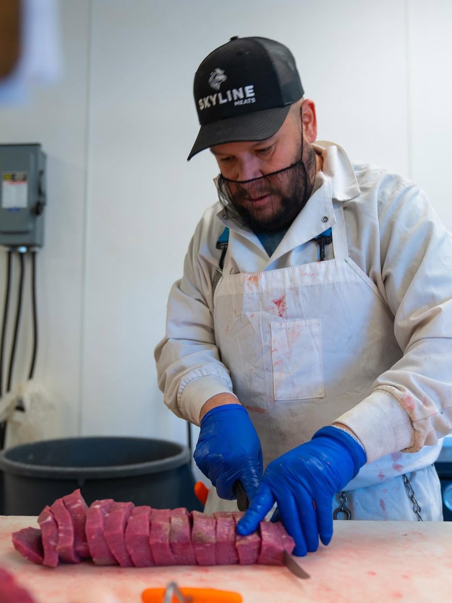 Skyline Meats butcher hand-cutting meat